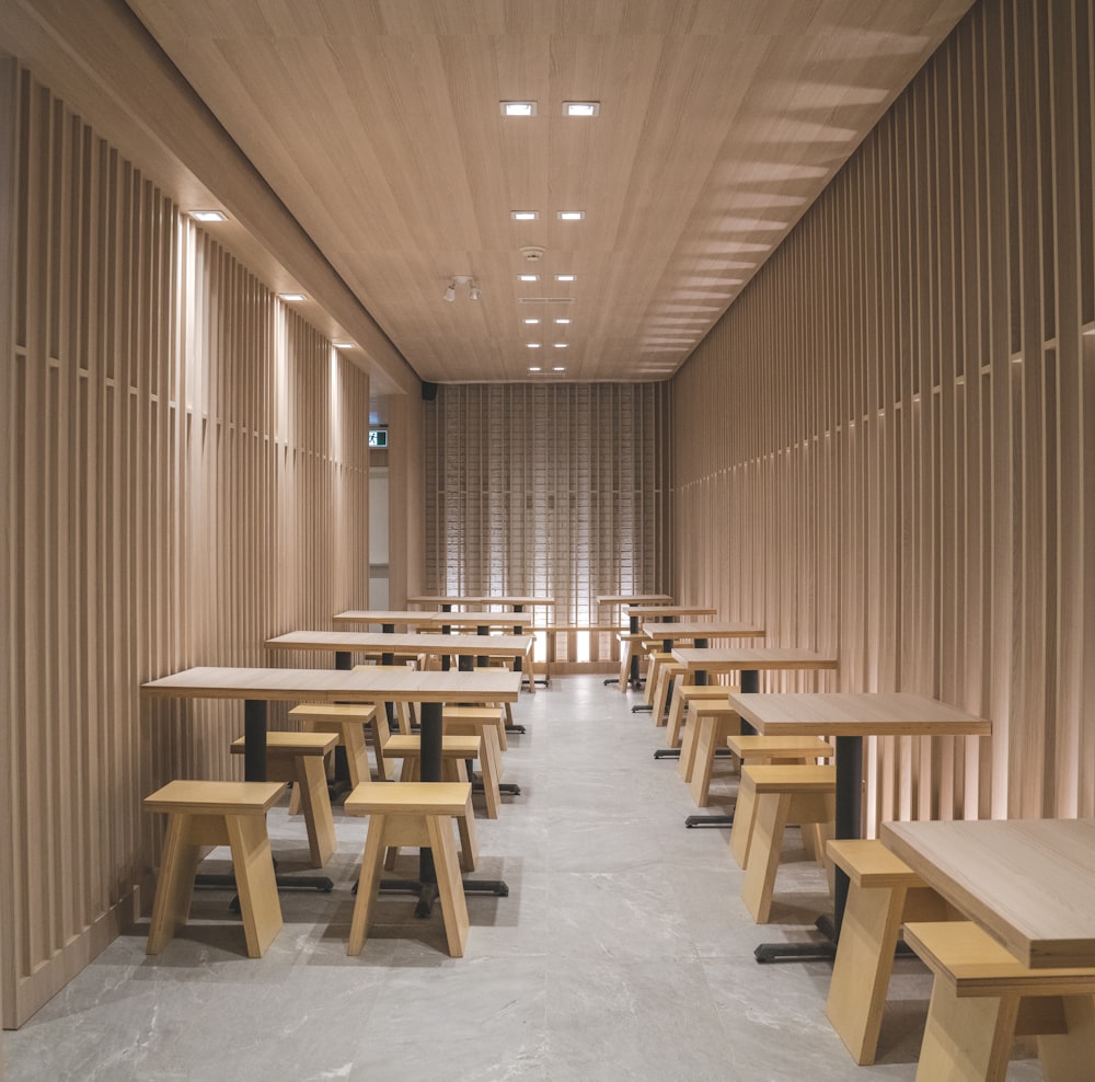 a room filled with wooden tables and benches