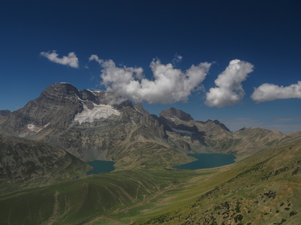 a view of a mountain range with a lake in the foreground