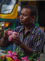 A friendly florist arranging a bouquet while a yallayalla driver waits outside the shop.