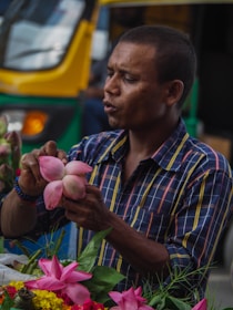 A family member carefully selecting fresh flowers at the local market early in the morning.