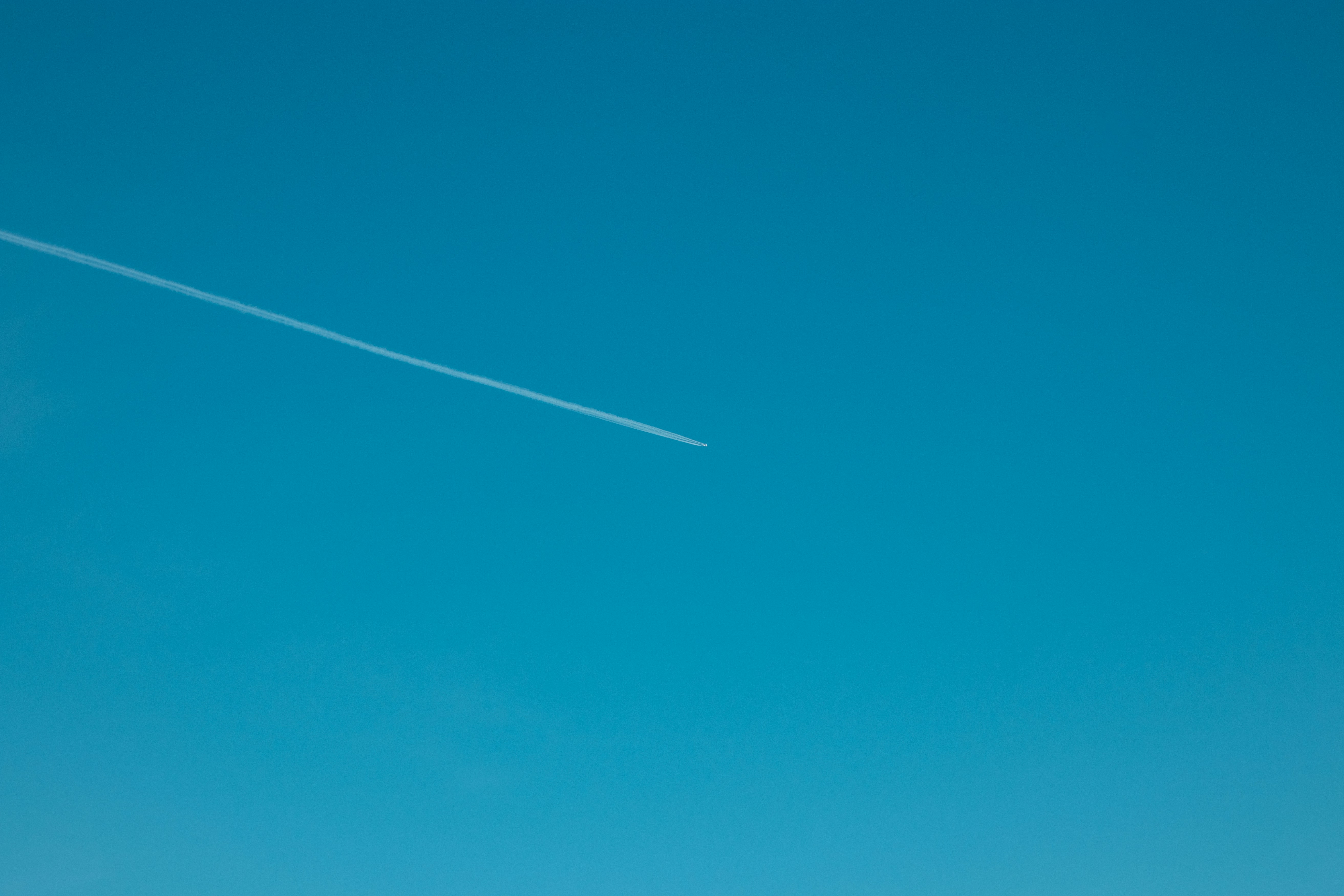 Plane through a clear blue sky, pattern, texture.