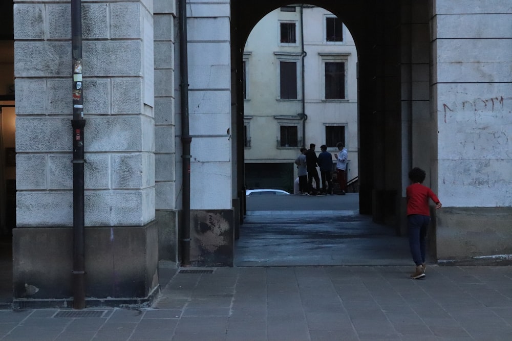 boy waling towards arch hallway