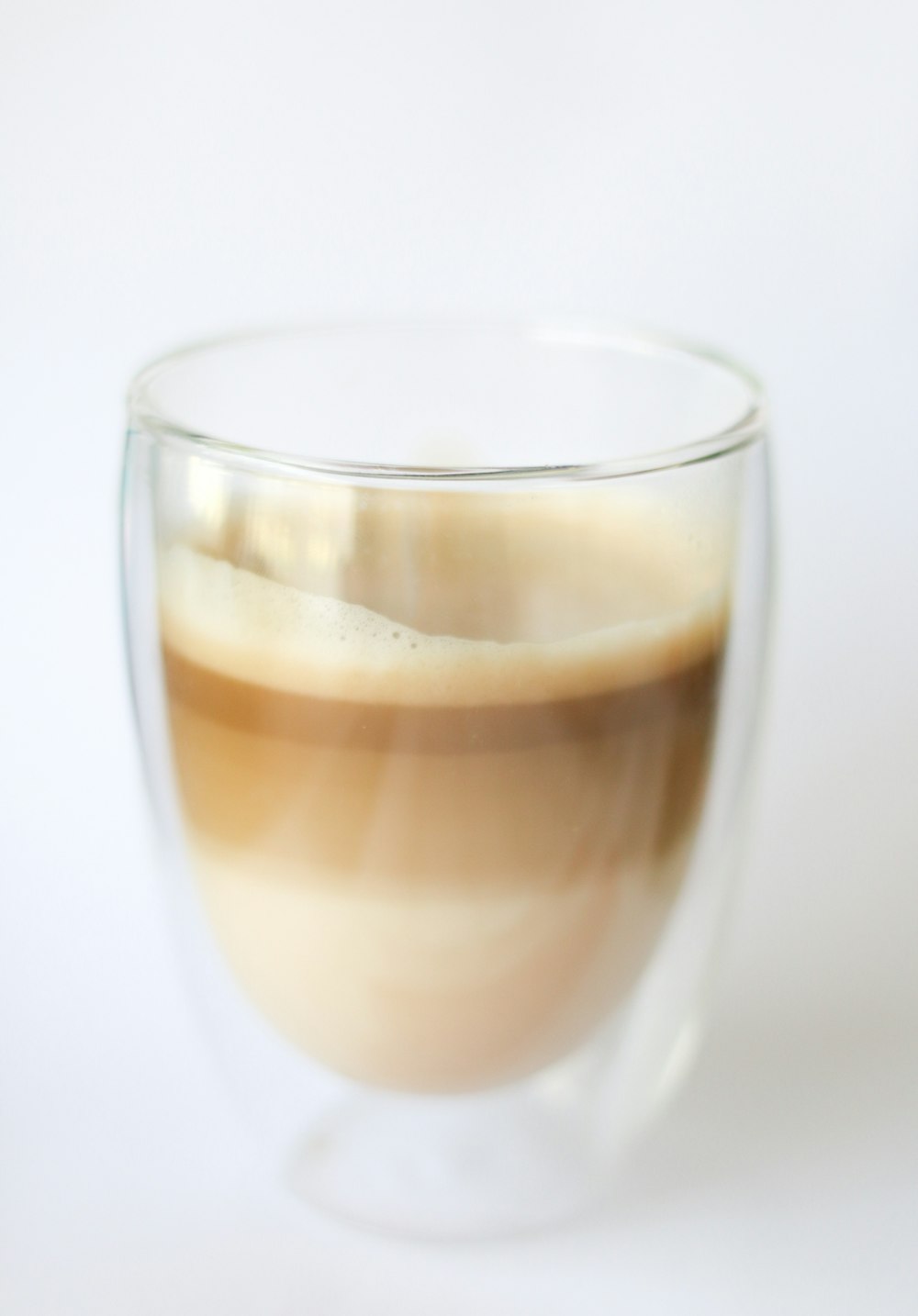 brown beverage in glass cup