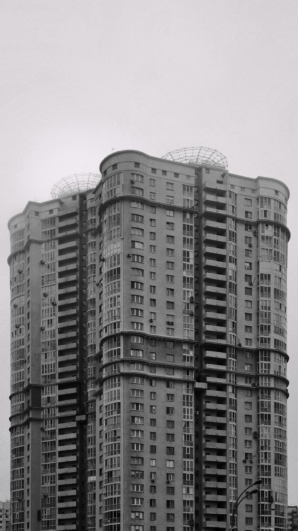 high rise building under white clouds