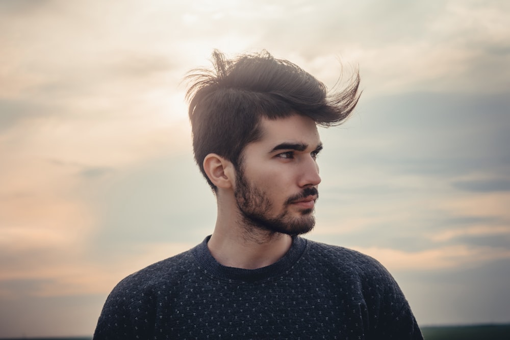 man wearing blue crew-neck top