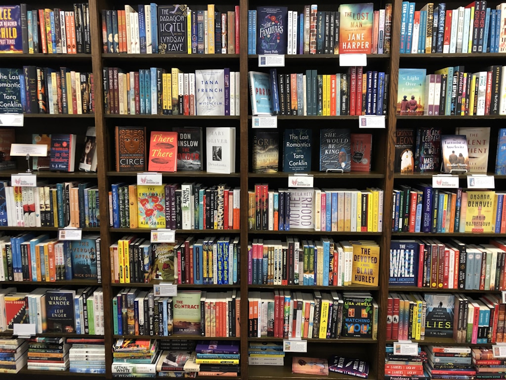 bookstore shelves, with stacks on the floor
