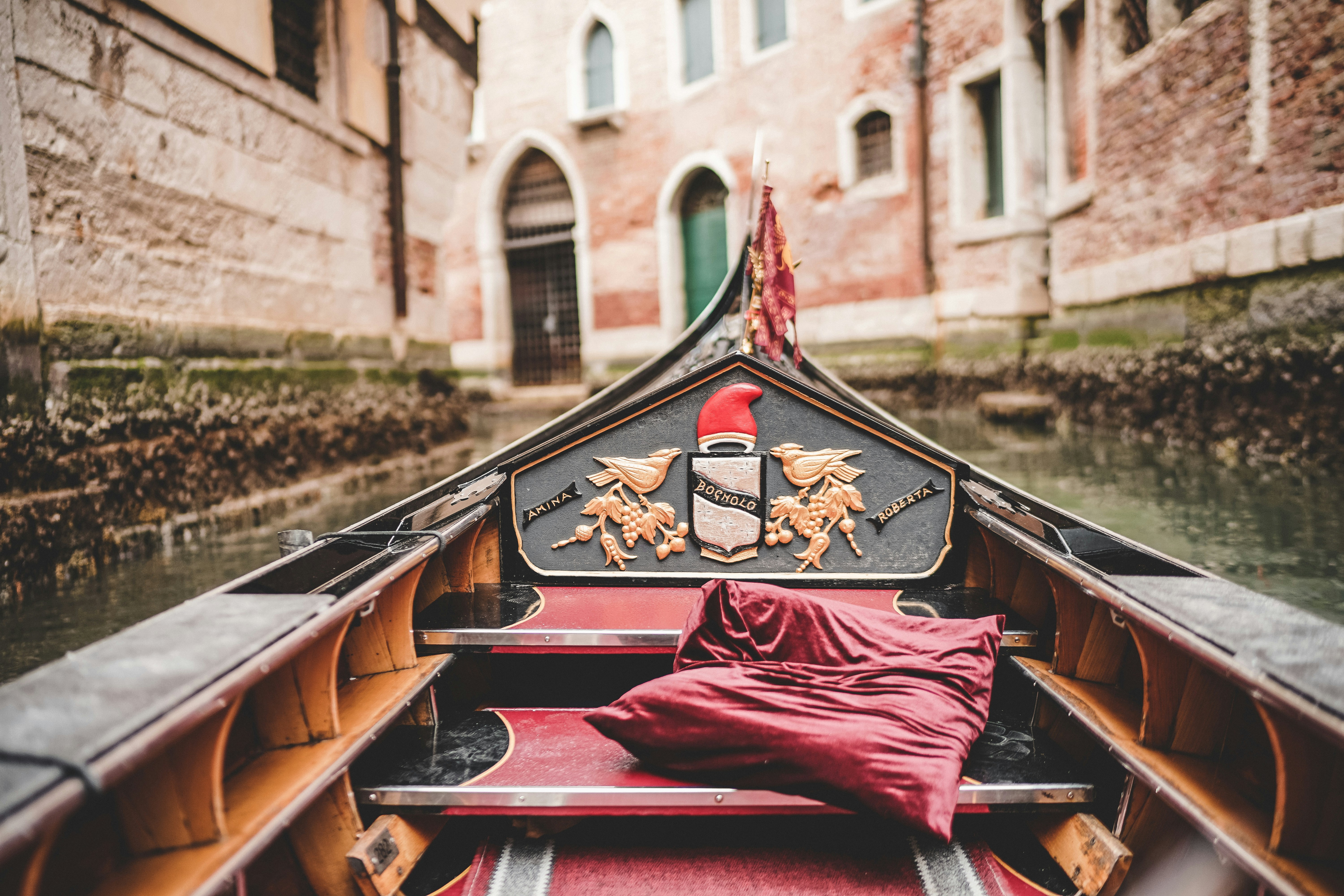 photo of brown and black wooden canoe boat
