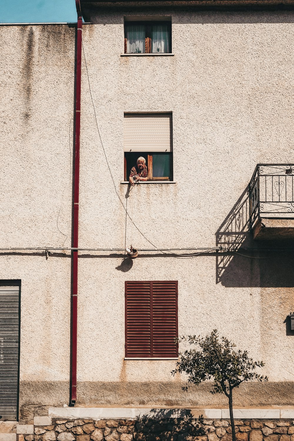 person on window during daytime