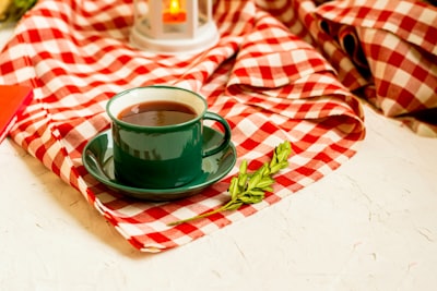 green ceramic teacup tablecloth teams background
