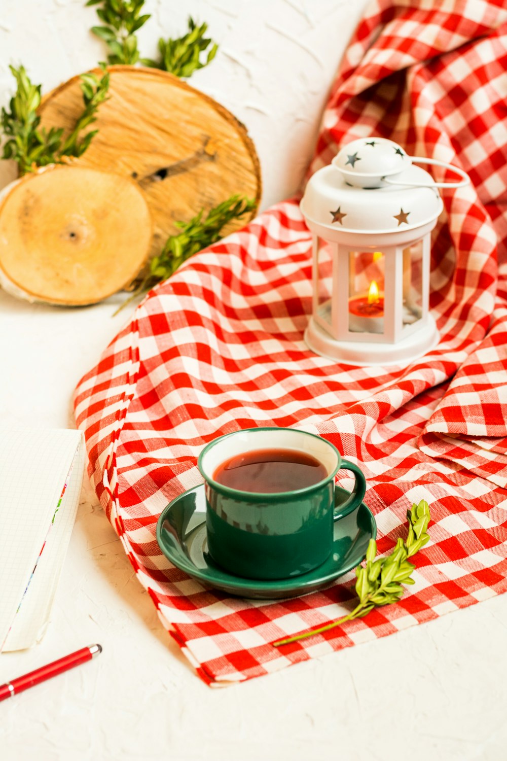 full filled tea cup on red blanket