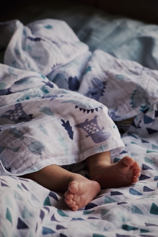 Close-up of a cozy baby blanket with gentle pastel patterns, folded neatly on a crib.