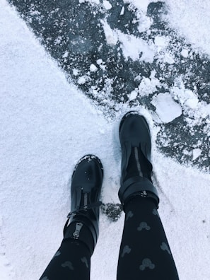 Outdoor workers using insulated boots in snowy conditions.
