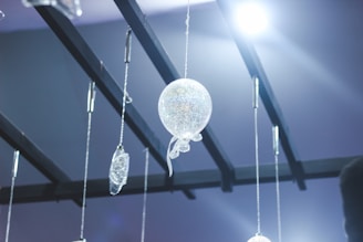 Elegant hanging ornaments displayed in a bright space.