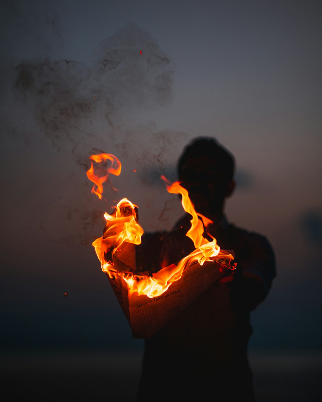person holding fire at night