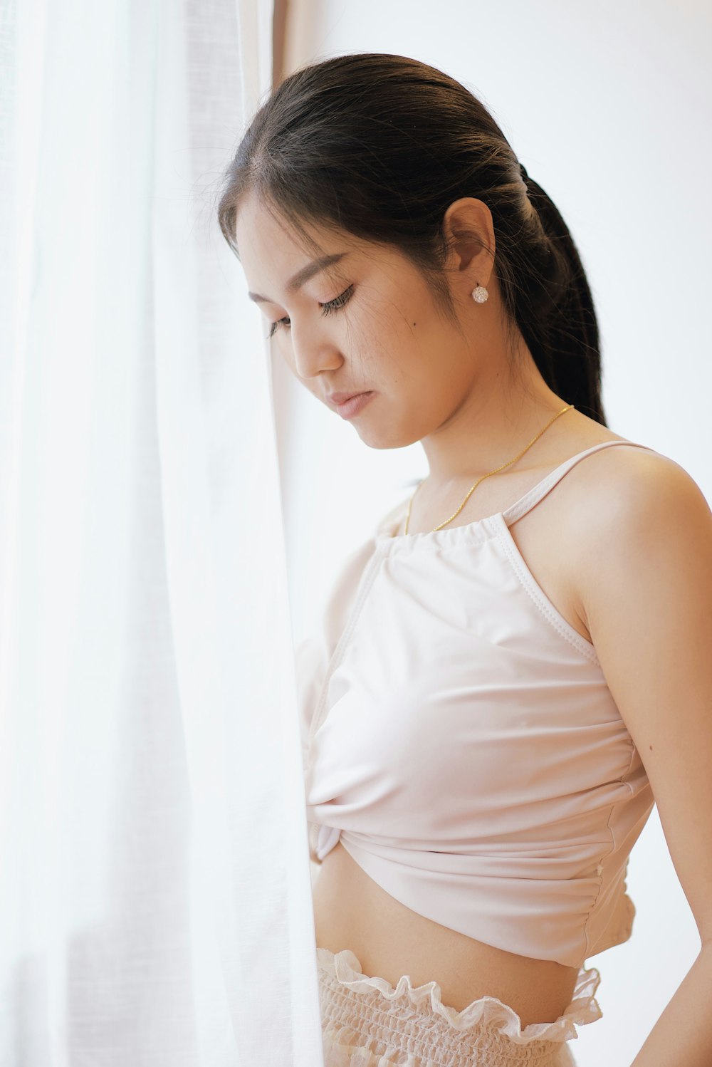 woman standing near white curtain