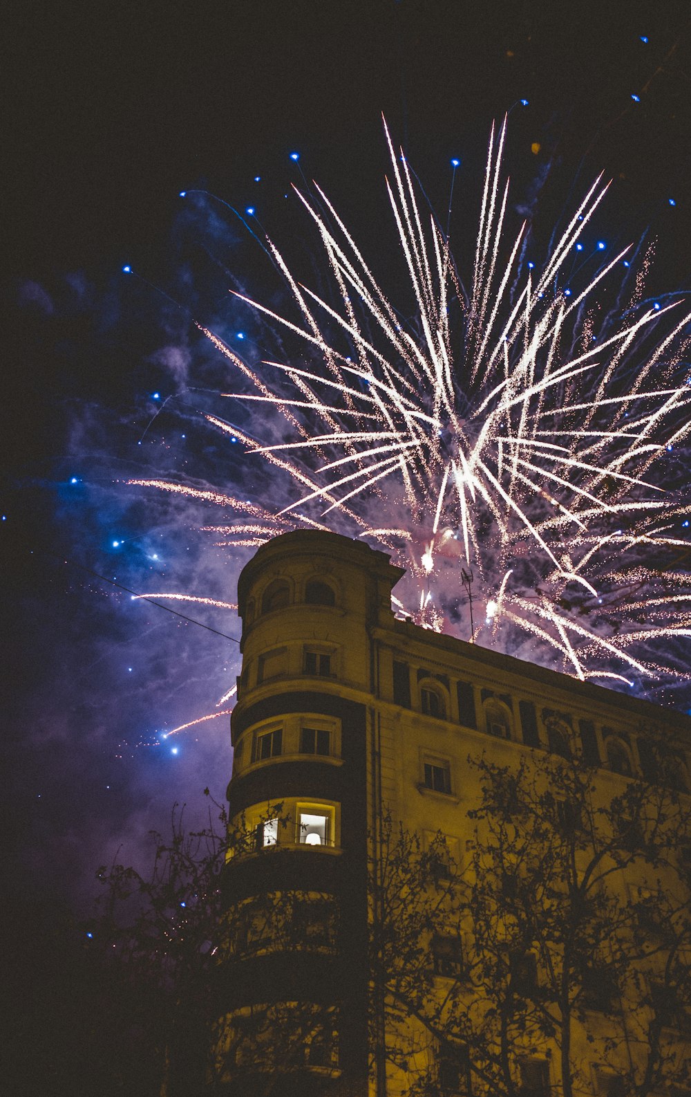 fireworks above brown concrete building
