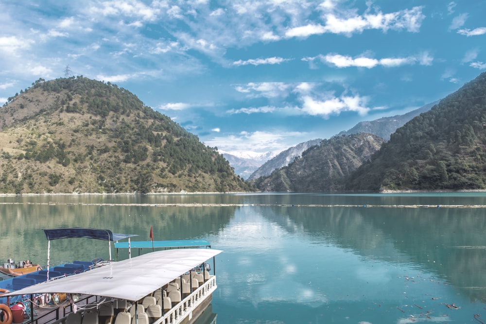 white passenger boat near mountains