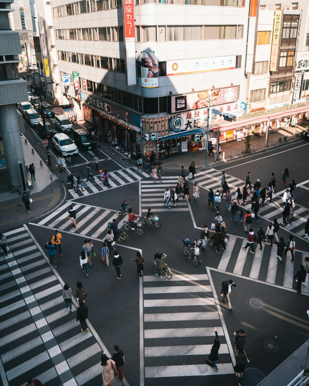 buildings and road full of people in it during daytime