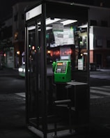 A serene phone booth with the Clairvoyance Premium logo glowing gently in the evening