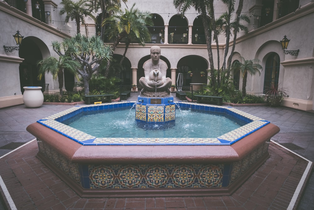 water fountain with statue between it