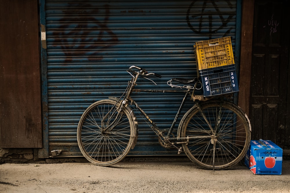 two crates on commuter bike parked beside roll-up door