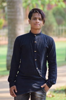 A model wearing a stylish short-sleeve shirt in a park.