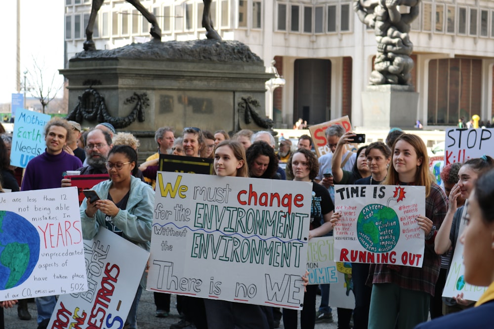 people gathering holding signage