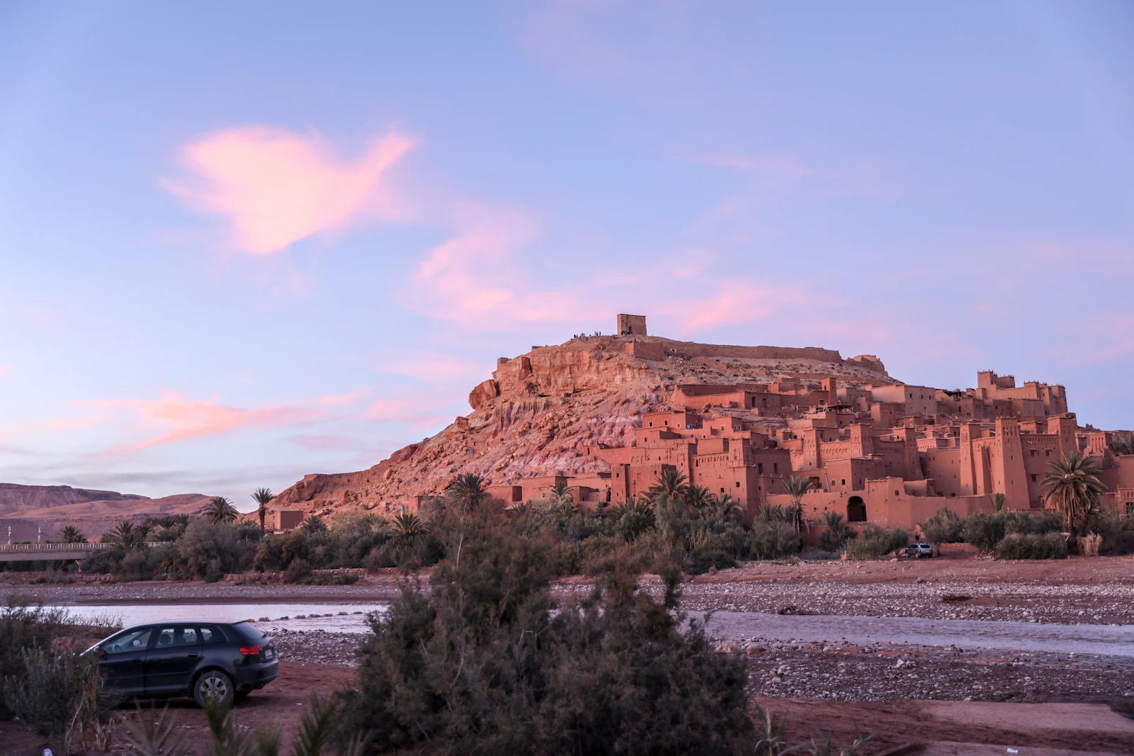 Ait Ben Haddou glowing beneath a pink evening sky