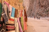 assorted clothes beside rock cliff