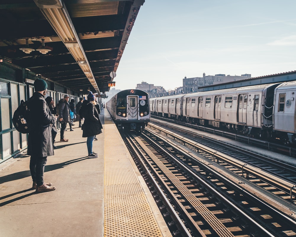 people standing on train station