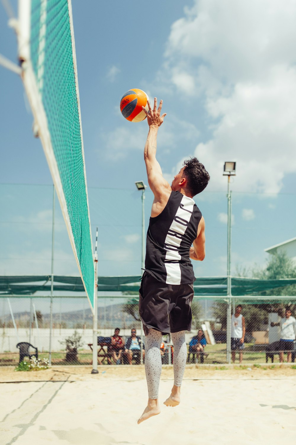 man about to hit the ball at volley court