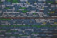 Lines of JavaScript code displayed on a computer screen with syntax highlighting. The text includes various functions, variables, and operations related to web development.