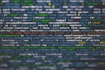 Lines of JavaScript code displayed on a computer screen with syntax highlighting. The text includes various functions, variables, and operations related to web development.