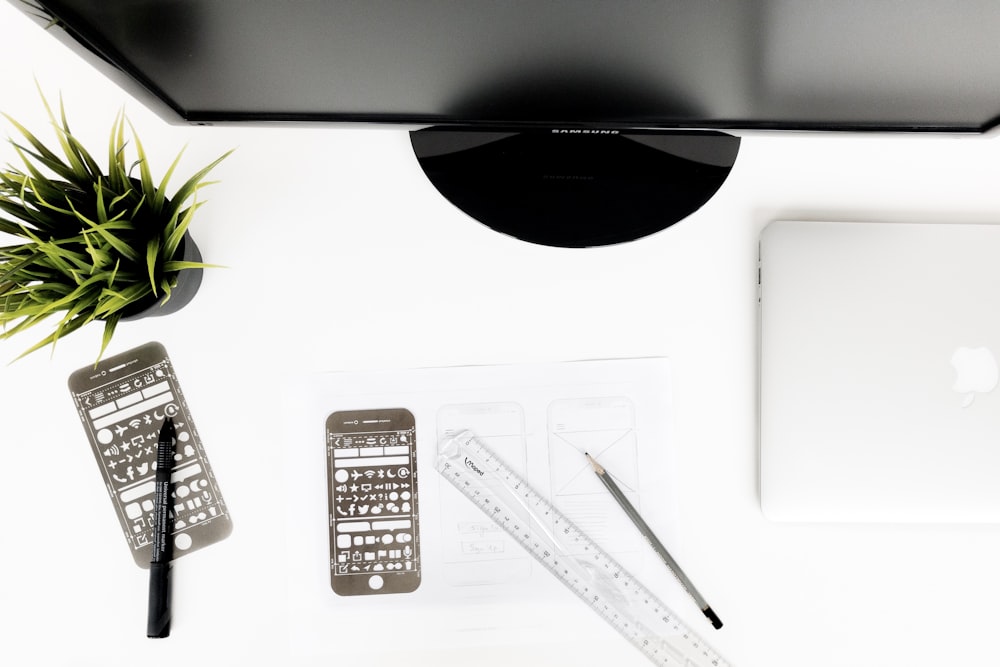 black flat screen computer monitor on white surface