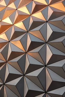 Close-up of intricate Moroccan tilework in warm gold and charcoal tones.