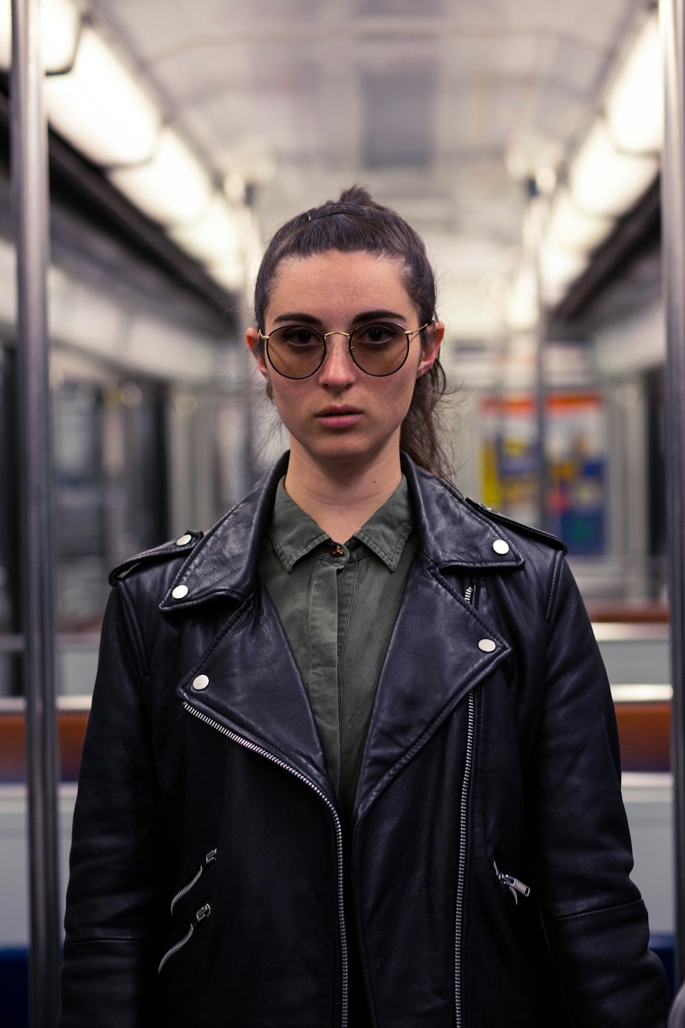 woman in black leather zip-up jacket standing inside vehicle