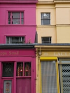 Brightly painted commercial building exterior with smooth charcoal grey accents in Pearland, TX.