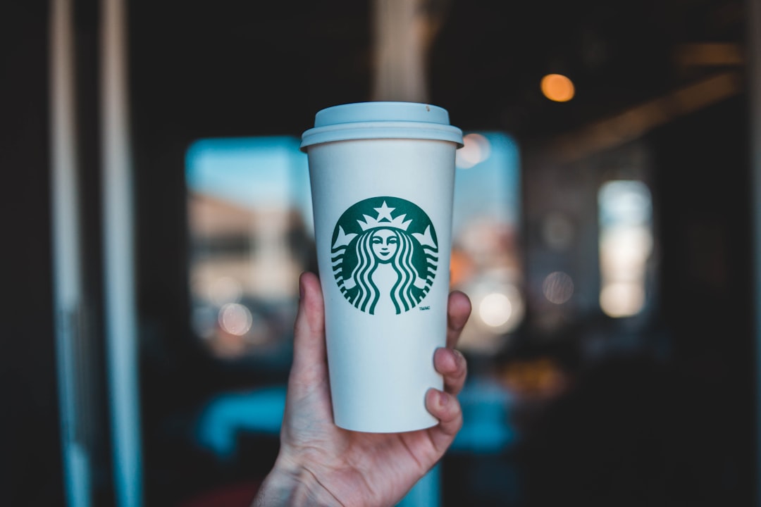 person holding Starbucks coffee cup