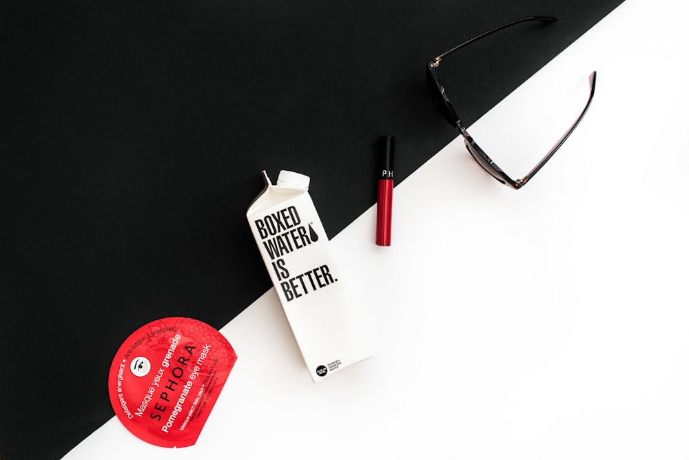 Sunglasses beside a carton of Boxed Water and Sephora products