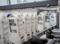 Workers inspecting quality of corrugated boxes on the production line.