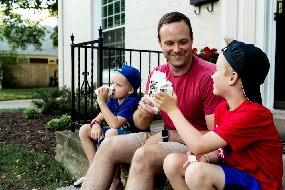 A father and his two boys enjoy drinking Boxed Water