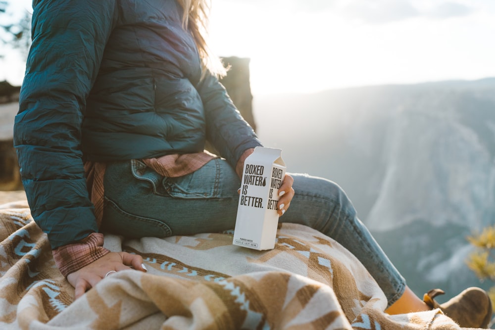 A woman holding a white Boxed Water carton in Yosemite National Park