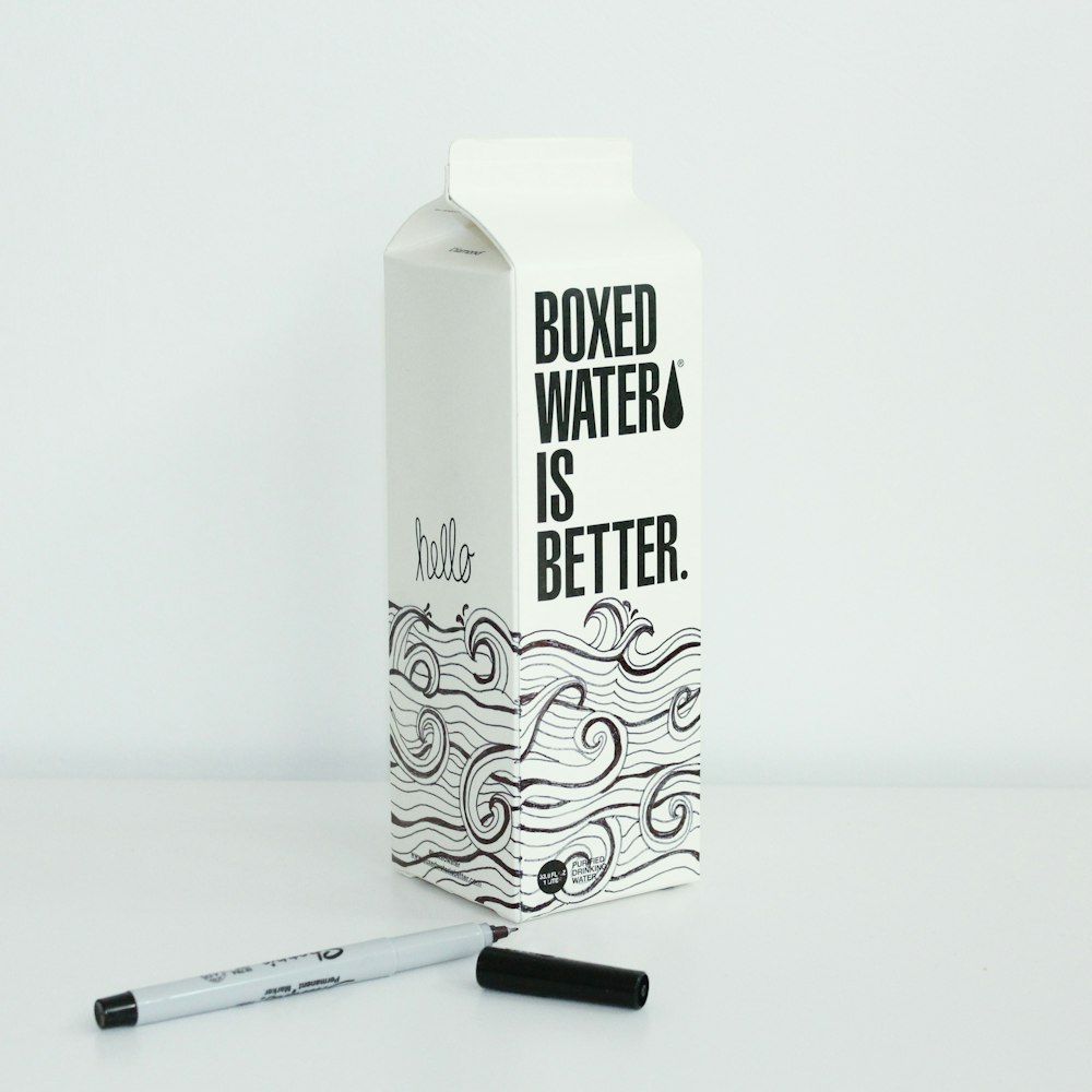 Boxed water is Better carton with waves drawn on it with a sharpie