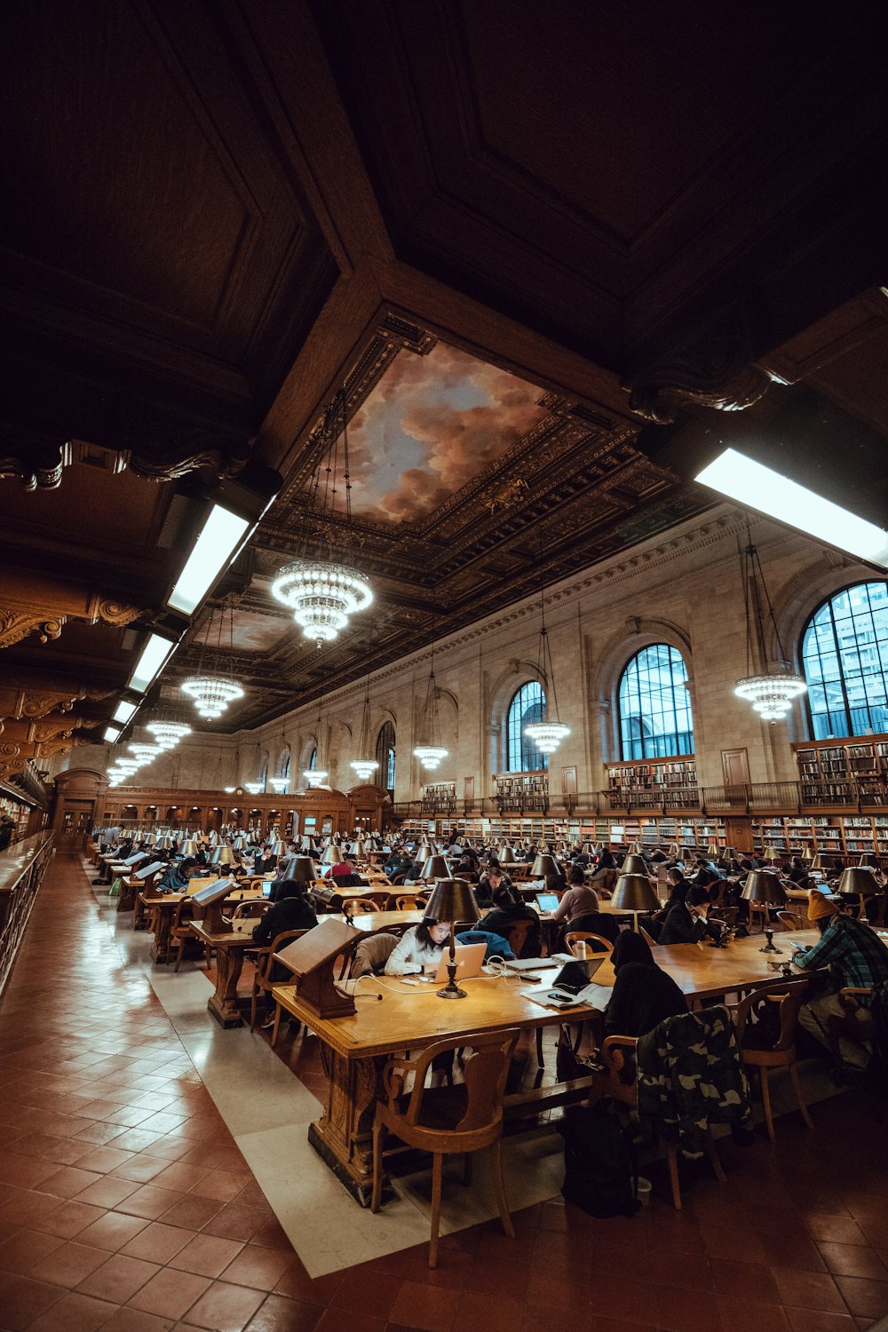 people sitting on chairs in front of table inside brown room