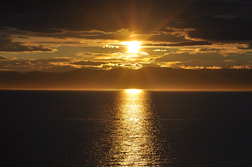 calm body of water during golden hour