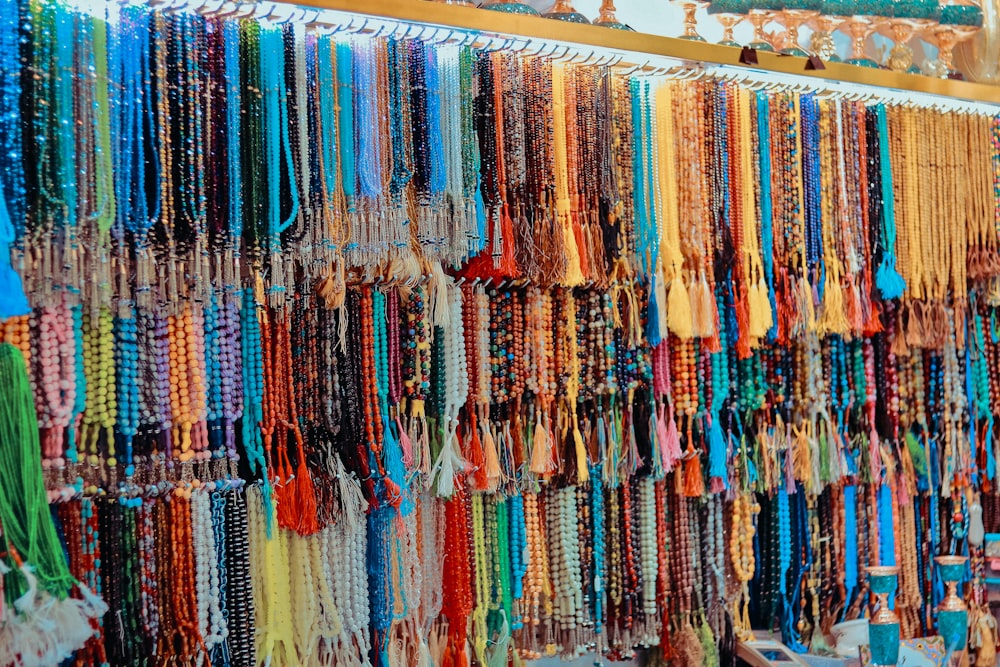 assorted-color prayer beads hanging on rack lot