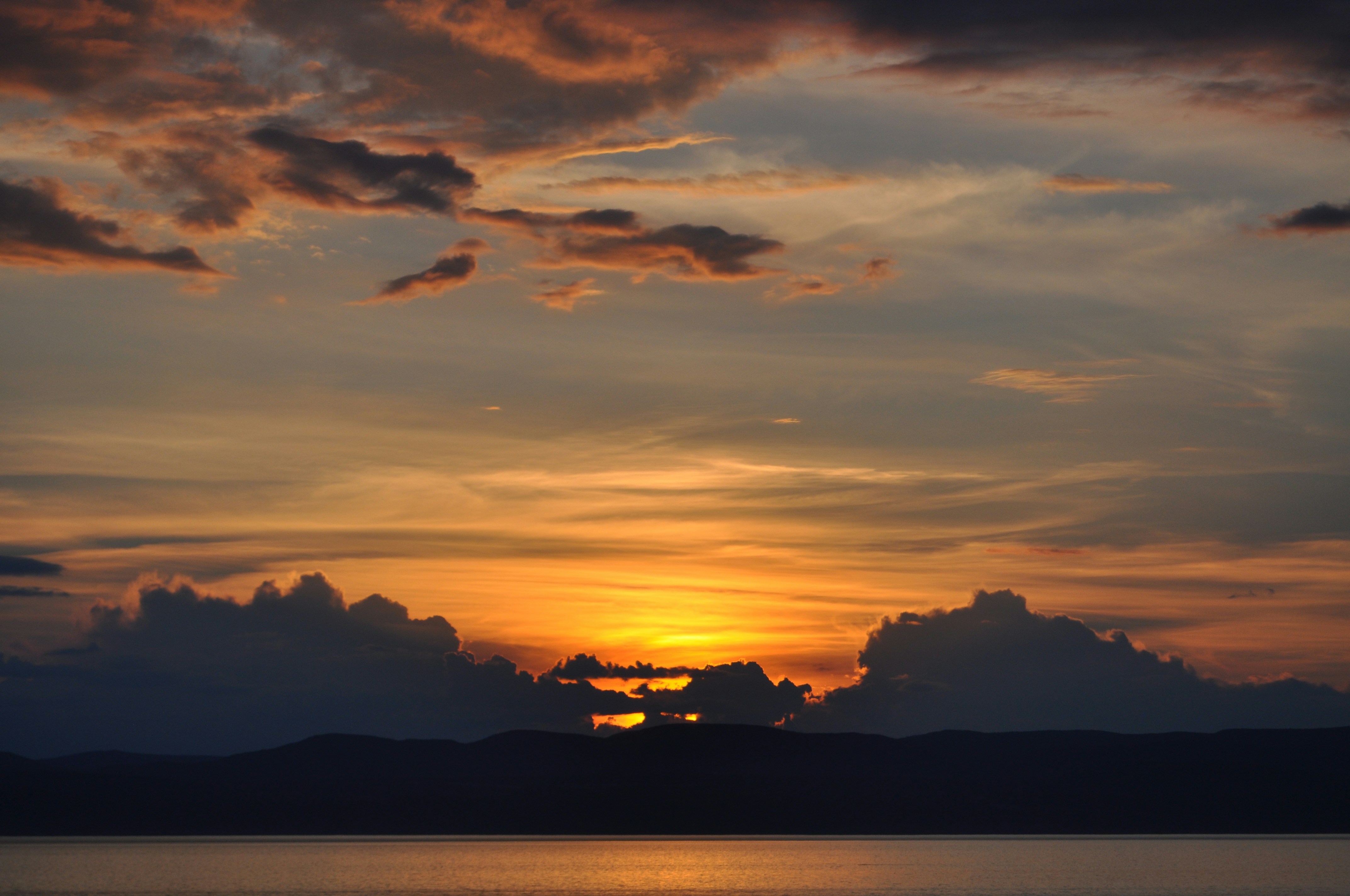 Calm body of water overlooking mountain during golden hour photo – Free ...