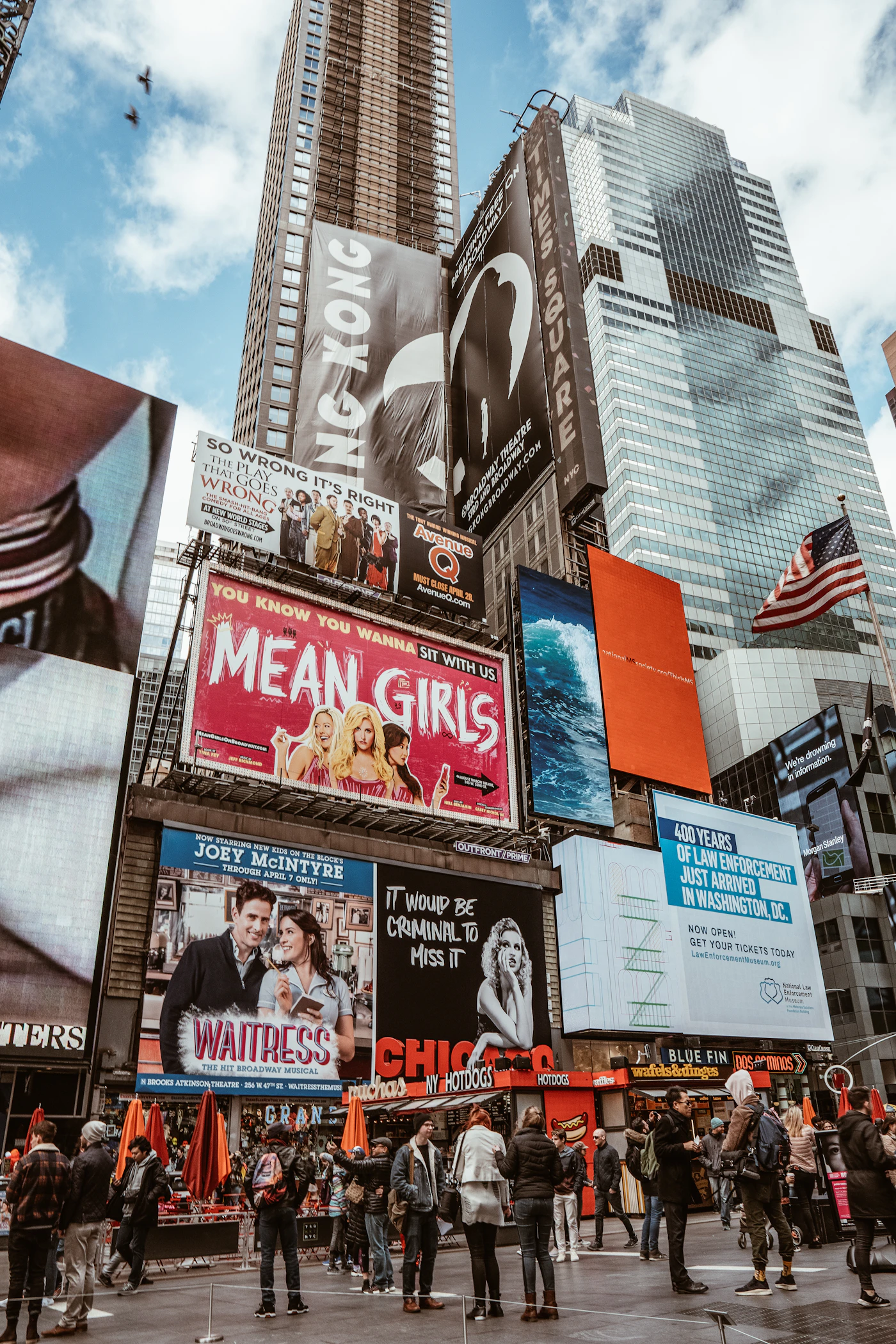 Times Square billboards above a crowded street