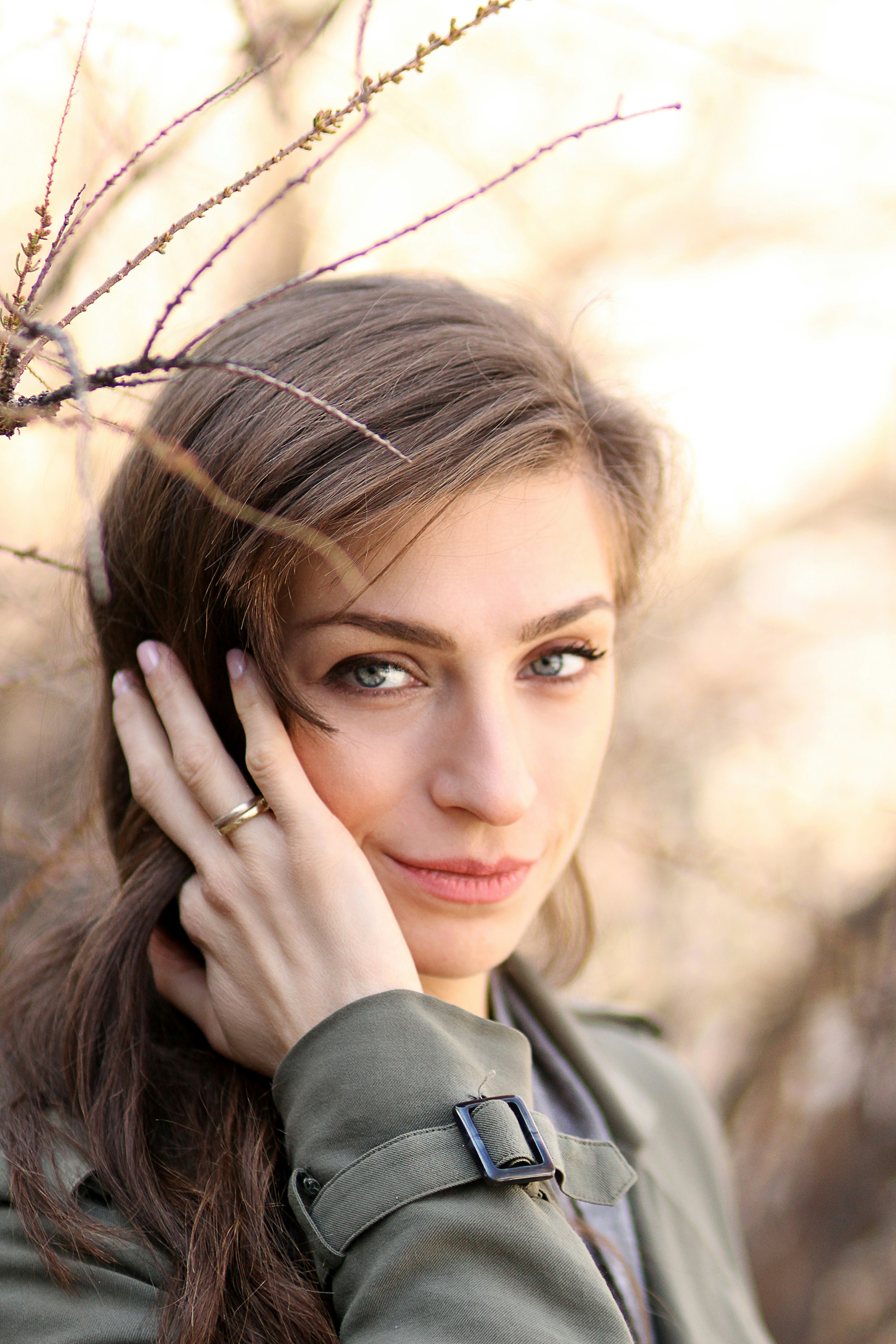 unknown celebrity standing near bare tree