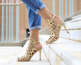 woman wearing brown leather heeled sandals walking on staircase